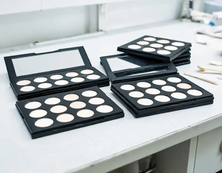empty eyeshadow palette bulk on a cosmetics bench, illustration only